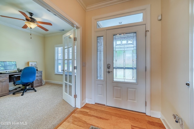 entrance foyer featuring crown molding, baseboards, plenty of natural light, and ceiling fan