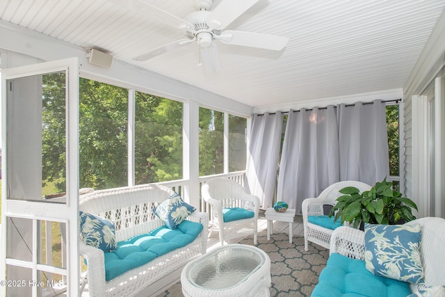 sunroom / solarium with ceiling fan, a wealth of natural light, and an outdoor hangout area