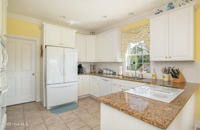 kitchen with crown molding, a sink, white appliances, a peninsula, and white cabinetry