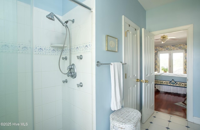 bathroom featuring a ceiling fan, a shower stall, and ensuite bath