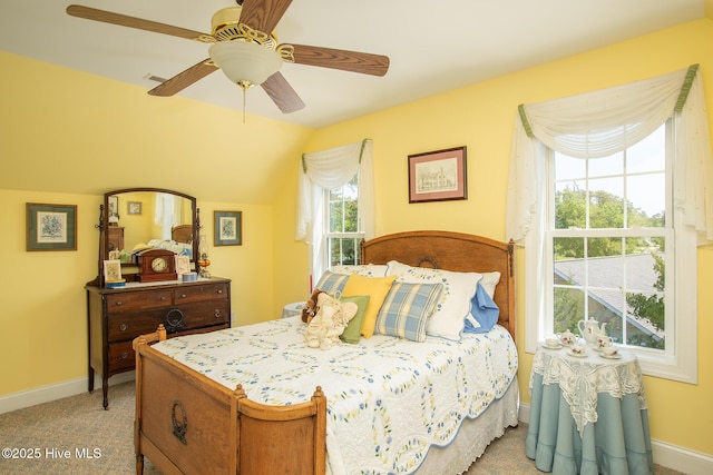 bedroom with visible vents, lofted ceiling, carpet flooring, baseboards, and a ceiling fan