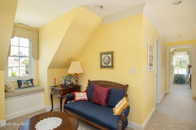 living area with crown molding, carpet floors, baseboards, and visible vents
