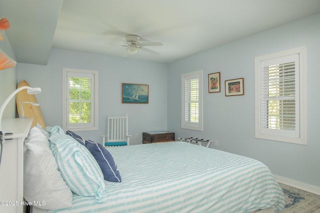 bedroom featuring baseboards and ceiling fan