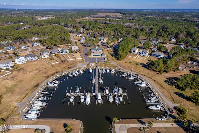 birds eye view of property with a water view and a forest view