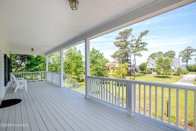 wooden deck with a yard and a porch