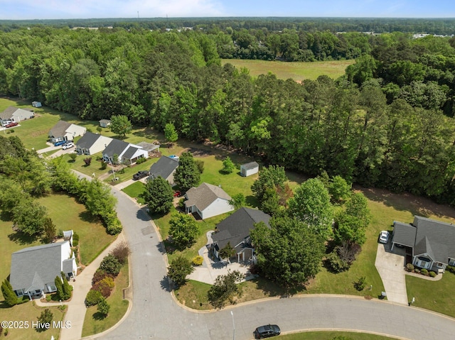 birds eye view of property featuring a residential view and a wooded view
