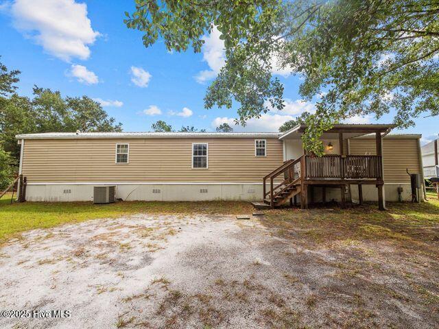336 Old Folkstone Rd, Holly Ridge, NC 28445 - back of property with central AC unit, stairway, and crawl space
