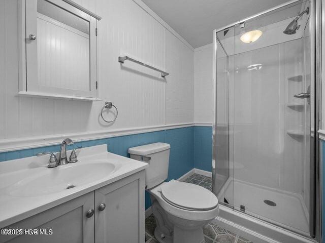 336 Old Folkstone Rd, Holly Ridge, NC 28445 - bathroom featuring tile patterned flooring, vanity, toilet, ornamental molding, and a stall shower
