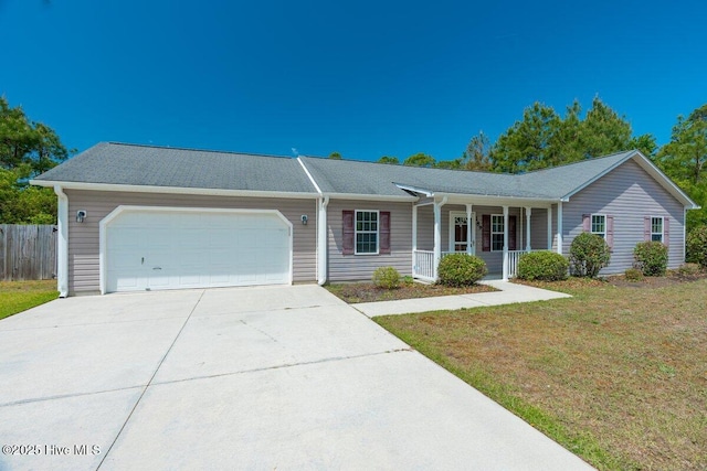 189 Queens Haven Rd, Hubert, NC 28539 - single story home featuring driveway, fence, covered porch, an attached garage, and a front lawn