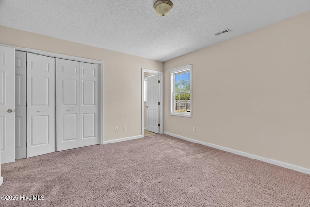 189 Queens Haven Rd, Hubert, NC 28539 - unfurnished bedroom with a closet, a textured ceiling, carpet, visible vents, and baseboards