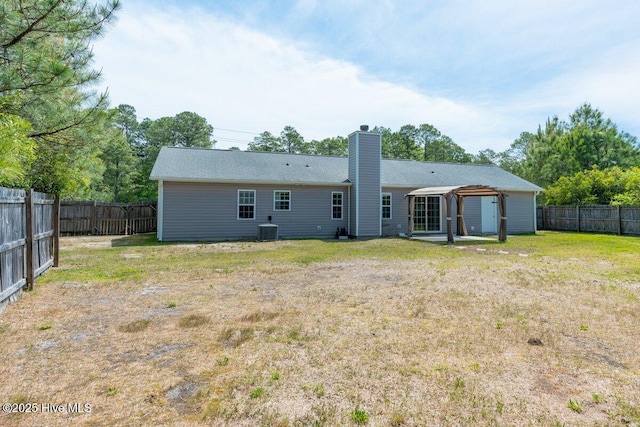 189 Queens Haven Rd, Hubert, NC 28539 - rear view of house featuring a yard, central AC unit, a chimney, and a fenced backyard