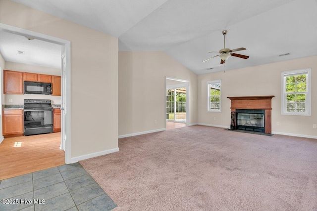 189 Queens Haven Rd, Hubert, NC 28539 - unfurnished living room with a ceiling fan, a fireplace with flush hearth, light carpet, baseboards, and vaulted ceiling