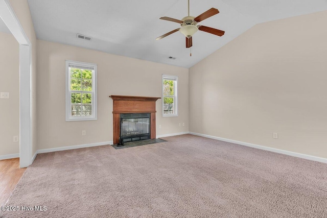189 Queens Haven Rd, Hubert, NC 28539 - unfurnished living room featuring a ceiling fan, baseboards, visible vents, a fireplace with flush hearth, and vaulted ceiling
