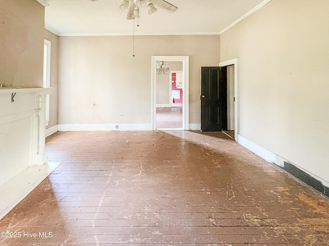 unfurnished living room featuring crown molding, baseboards, and ceiling fan