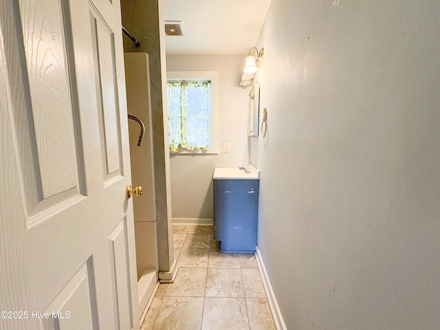 interior space with baseboards and a sink