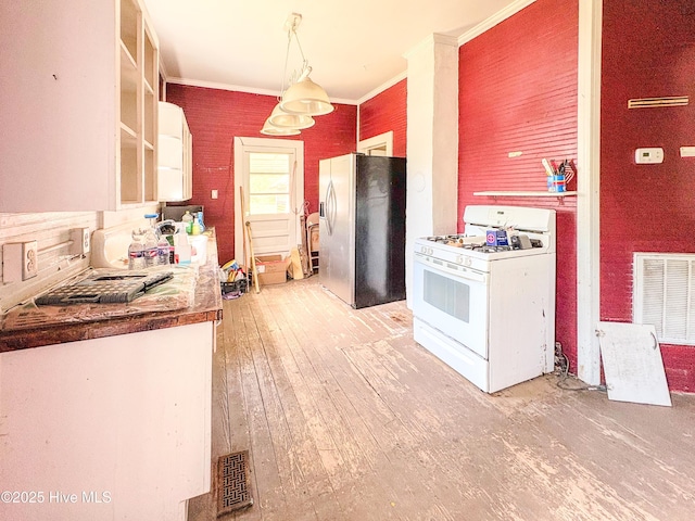 kitchen with visible vents, stainless steel fridge with ice dispenser, white gas range oven, light wood finished floors, and ornamental molding