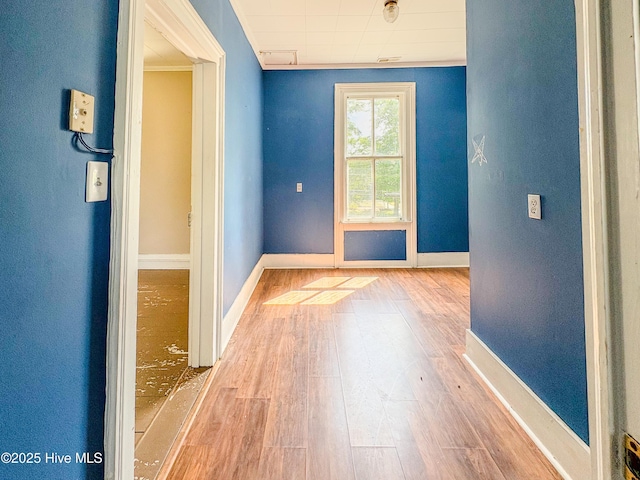 empty room featuring baseboards and wood finished floors