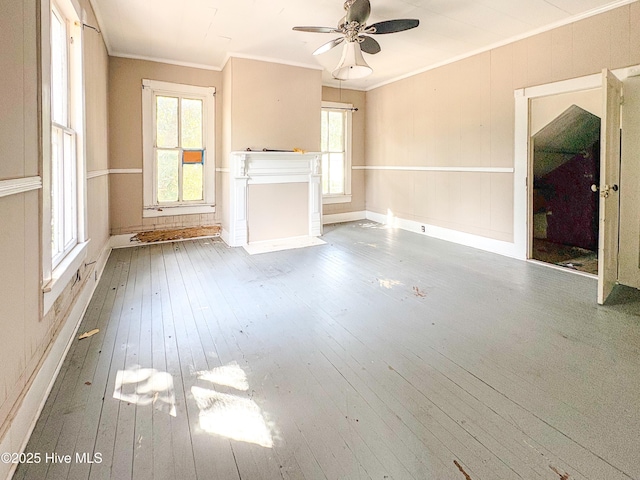 unfurnished living room featuring ornamental molding, hardwood / wood-style flooring, and ceiling fan