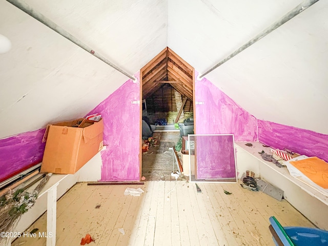 additional living space featuring hardwood / wood-style flooring and lofted ceiling