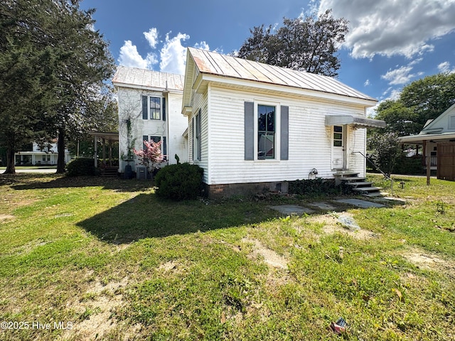 311 W Jones St, Trenton, NC 28585 - view of front of house with a front yard, metal roof, entry steps, and a standing seam roof