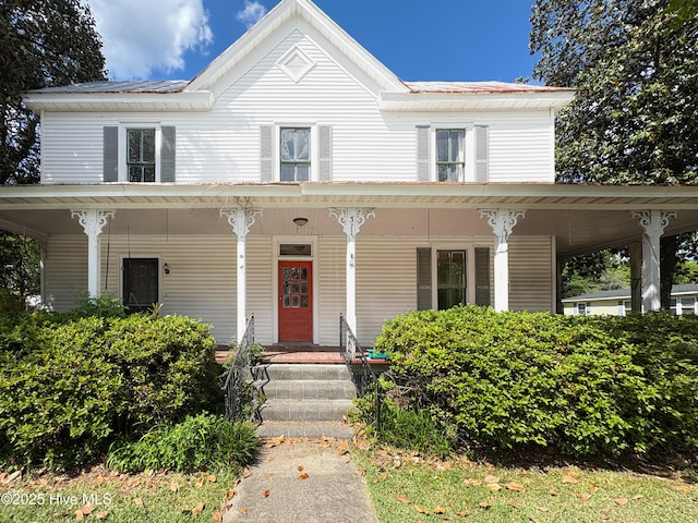 farmhouse inspired home featuring covered porch