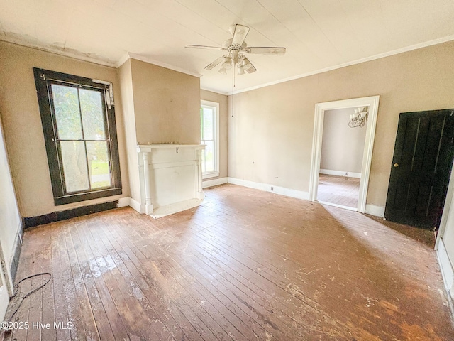 unfurnished living room featuring crown molding, wood-type flooring, ceiling fan, and baseboards