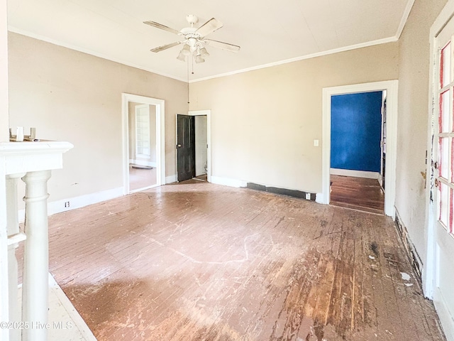 unfurnished room with baseboards, ornamental molding, ceiling fan, and wood finished floors