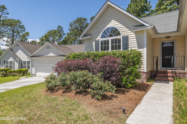 single story home with an attached garage, driveway, a shingled roof, and a front lawn