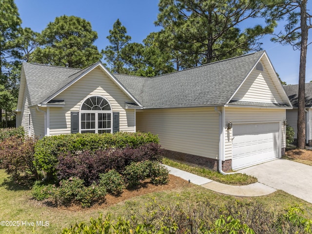 ranch-style house with an attached garage, driveway, and roof with shingles