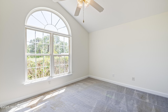 spare room with carpet floors, ceiling fan, baseboards, and lofted ceiling