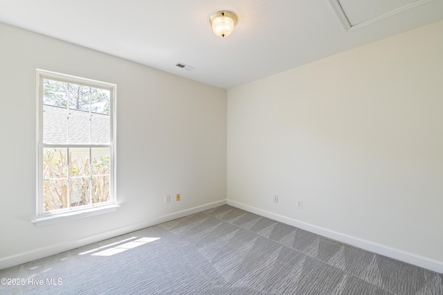 carpeted empty room featuring visible vents and baseboards