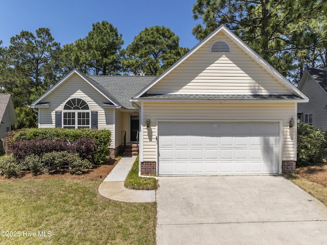ranch-style home featuring a garage, a shingled roof, a front yard, and concrete driveway