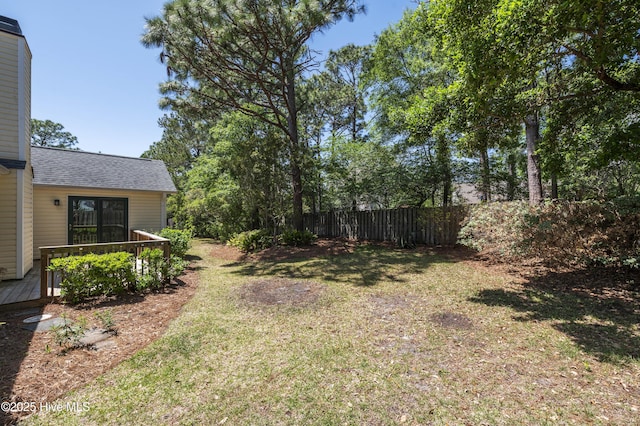 view of yard with fence and a wooden deck