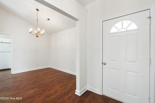 foyer featuring dark wood-style flooring, visible vents, vaulted ceiling, baseboards, and a notable chandelier
