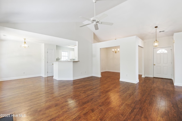 unfurnished living room with baseboards, ceiling fan with notable chandelier, dark wood-style flooring, and visible vents