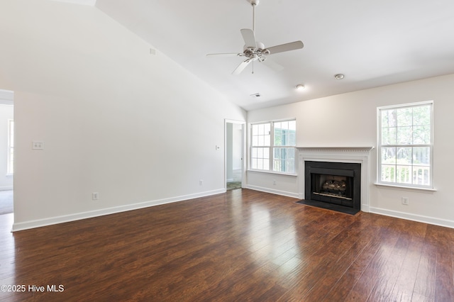 unfurnished living room featuring dark wood-style flooring, baseboards, ceiling fan, high vaulted ceiling, and a fireplace with flush hearth