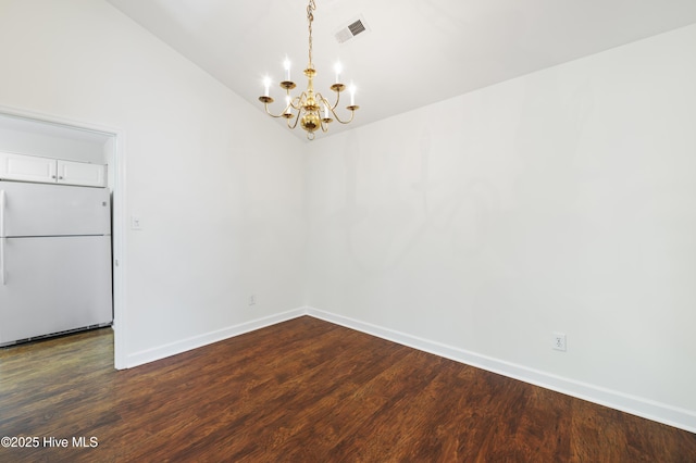 unfurnished dining area featuring baseboards, visible vents, dark wood-style floors, and an inviting chandelier