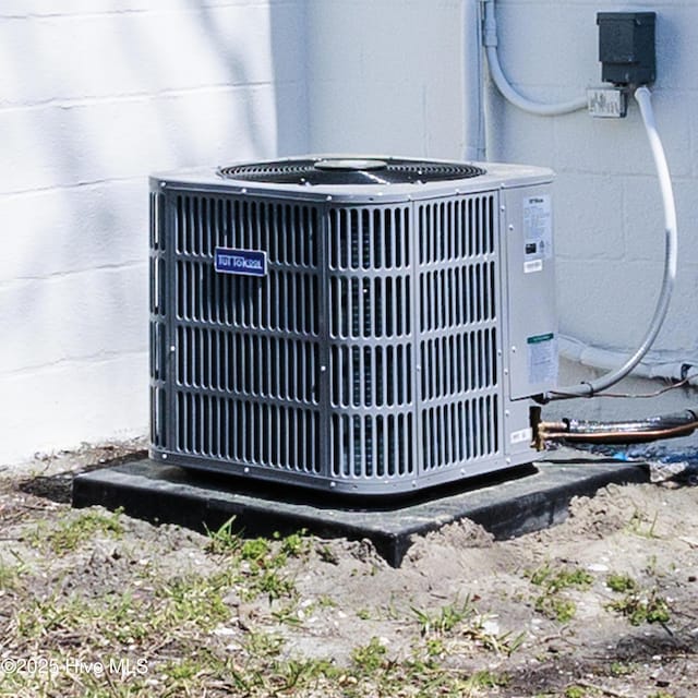exterior details with concrete block siding and central air condition unit