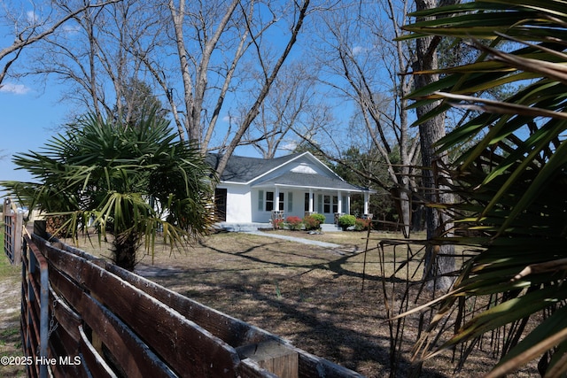 exterior space with a porch and fence