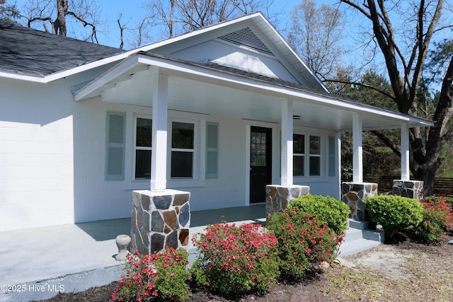 view of front of house featuring a shingled roof and a porch