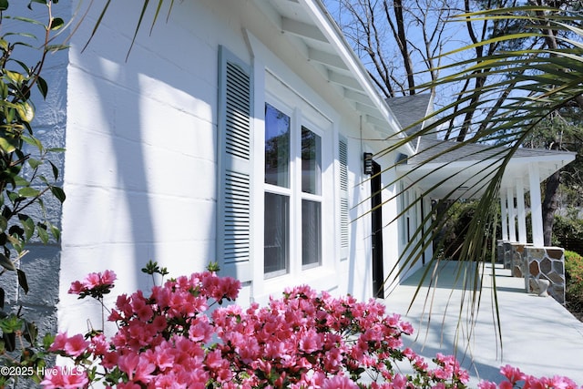 view of side of home with a shingled roof