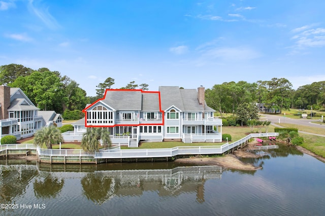 1710 Deerfield Ct SW Unit 4A, Ocean Isle Beach, NC 28469 - back of property featuring a water view, a chimney, a yard, and a balcony