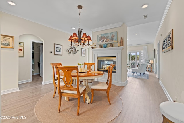 1710 Deerfield Ct SW Unit 4A, Ocean Isle Beach, NC 28469 - dining area with ornamental molding, recessed lighting, arched walkways, light wood-style floors, and a chandelier