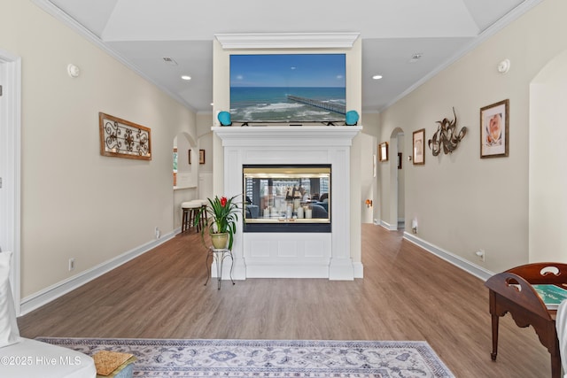 1710 Deerfield Ct SW Unit 4A, Ocean Isle Beach, NC 28469 - living area with arched walkways, wood finished floors, ornamental molding, recessed lighting, and baseboards