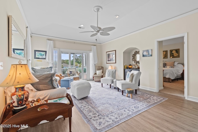 1710 Deerfield Ct SW Unit 4A, Ocean Isle Beach, NC 28469 - living area featuring crown molding, a ceiling fan, wood finished floors, arched walkways, and baseboards