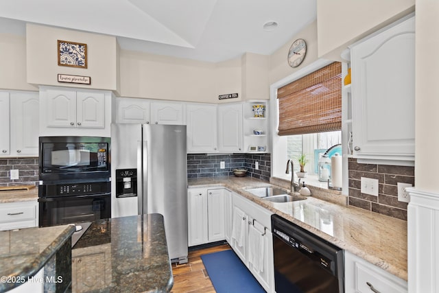 1710 Deerfield Ct SW Unit 4A, Ocean Isle Beach, NC 28469 - kitchen featuring black appliances, a sink, backsplash, and light wood-type flooring