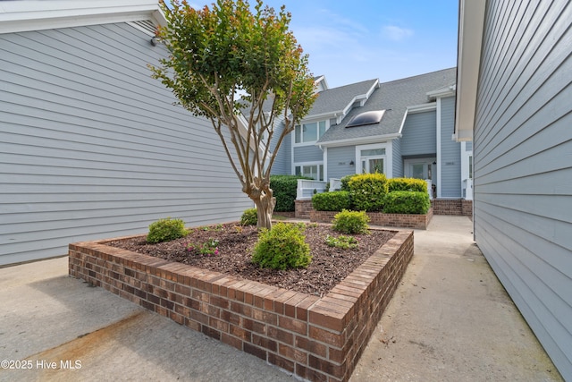 1710 Deerfield Ct SW Unit 4A, Ocean Isle Beach, NC 28469 - view of property exterior with roof with shingles