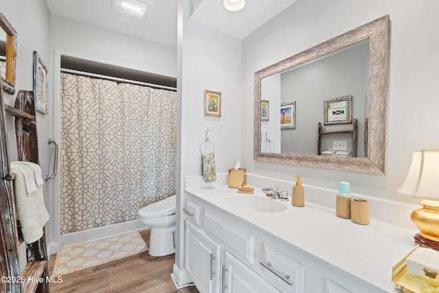 1710 Deerfield Ct SW Unit 4A, Ocean Isle Beach, NC 28469 - full bathroom with toilet, vanity, wood finished floors, and a shower with shower curtain