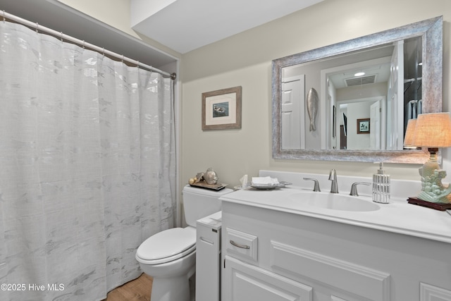 1710 Deerfield Ct SW Unit 4A, Ocean Isle Beach, NC 28469 - bathroom with toilet, wood finished floors, and vanity