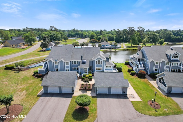 1710 Deerfield Ct SW Unit 4A, Ocean Isle Beach, NC 28469 - aerial perspective of suburban area featuring a nearby body of water and a tree filled landscape